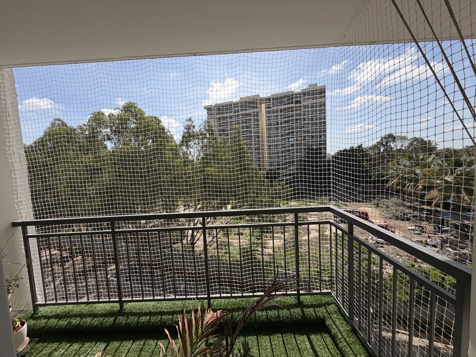 Corner balcony enclosed with white mesh netting